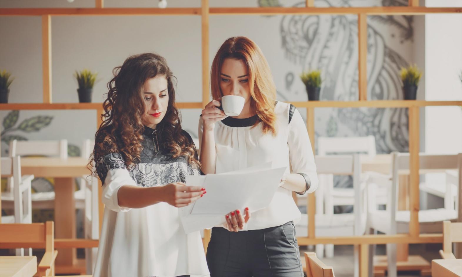 Business owner working with financial advisor reviewing profit and loss statements